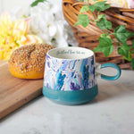 Be Still Floral Christian Mug on a table
