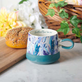 Be Still Floral Christian Mug on a table
